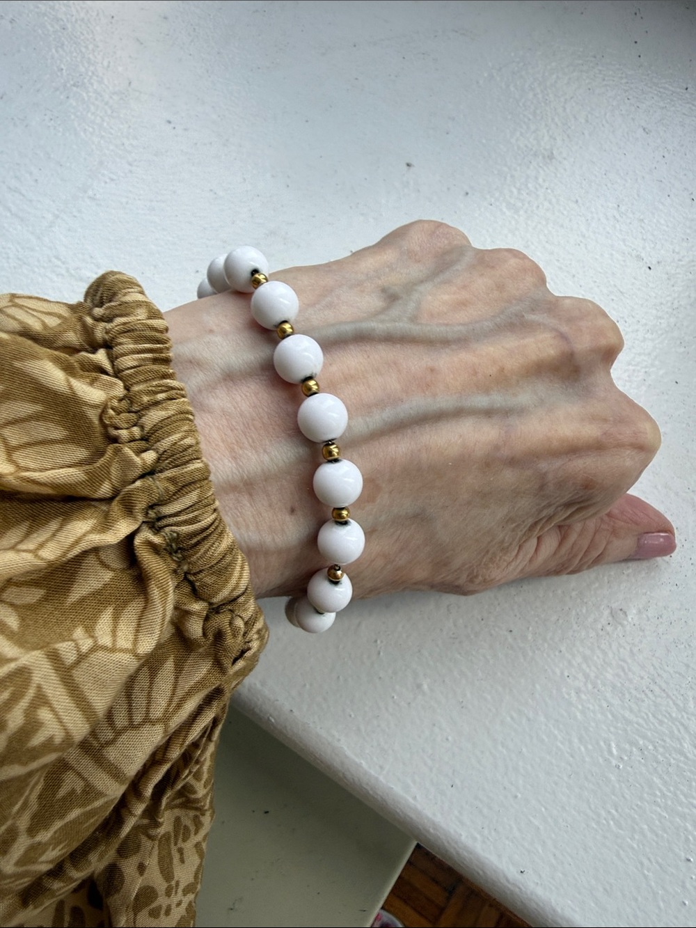 Monet Vintage White Beaded Bracelet with Gold Plated Spacers. Length 7.25 in.